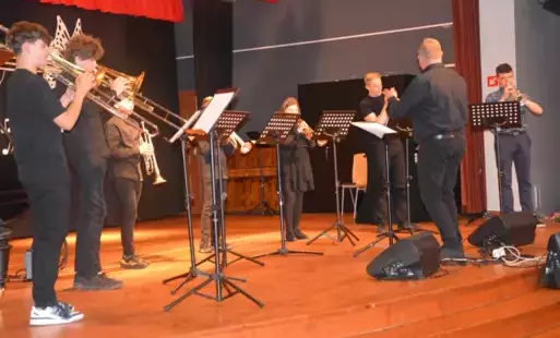na scenie stoją trębacze i grają na instrumentach